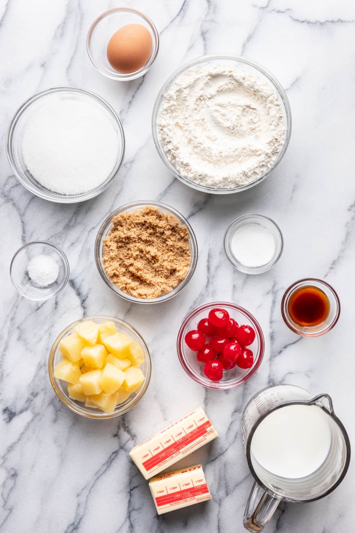 Ingredients for pineapple upside down cupcakes in dishes.