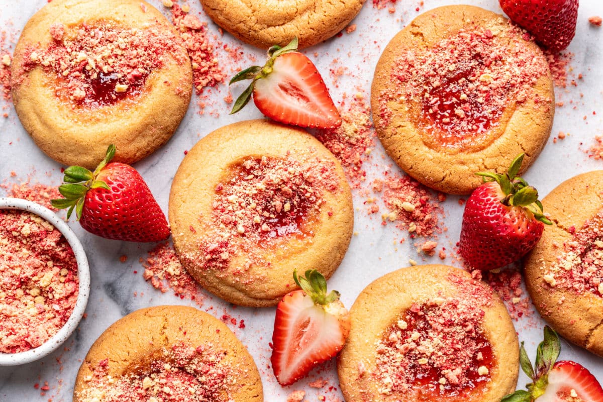 Strawberry shortcake cookies next to a dish of strawberry crumbs.