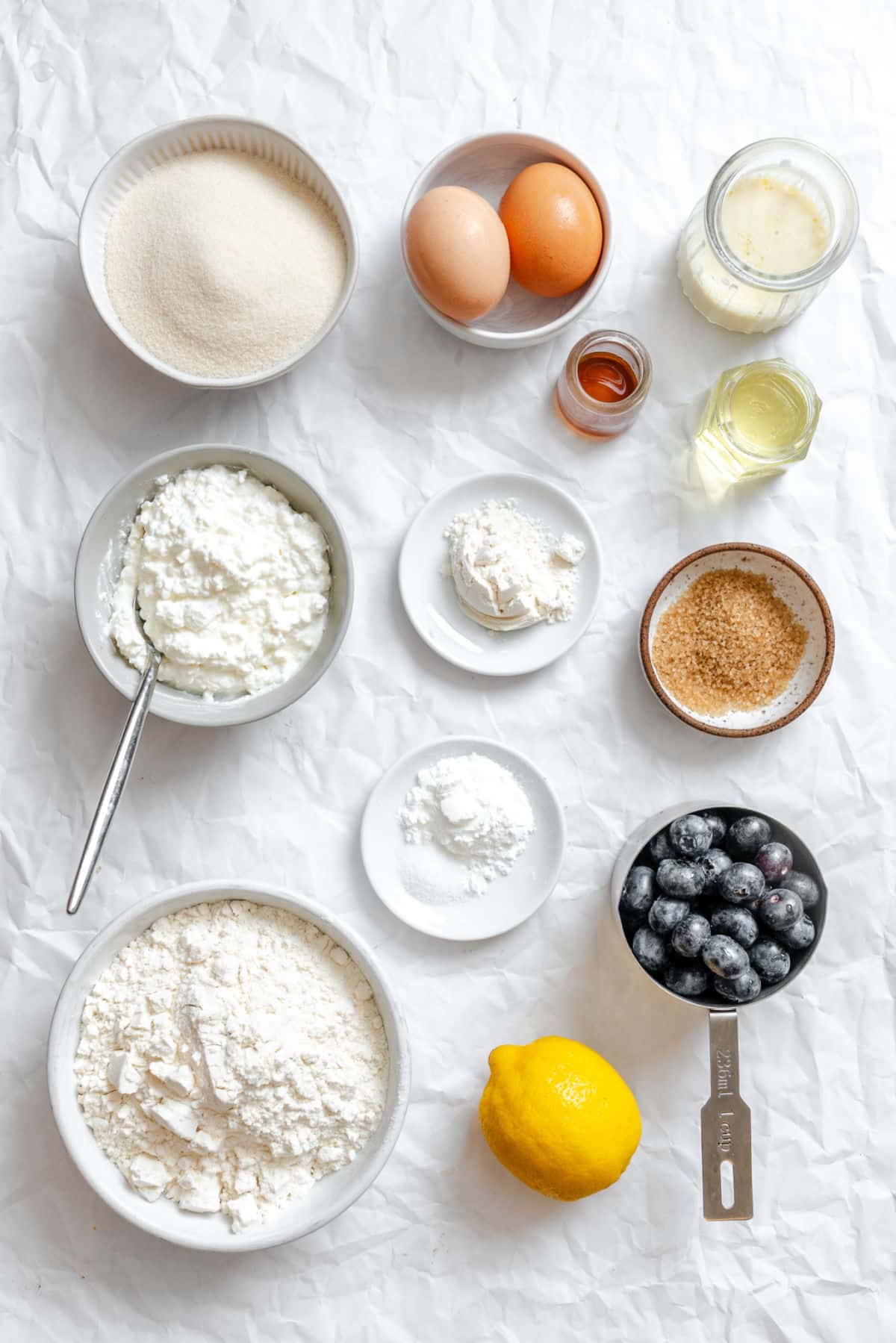 Ingredients for blueberry cottage cheese muffins in dishes.