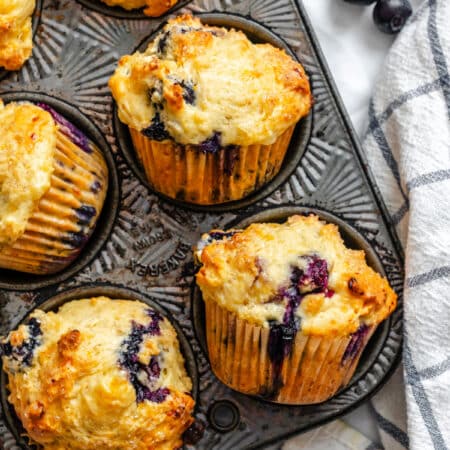 Baked blueberry cottage cheese muffins in a vintage muffin pan.