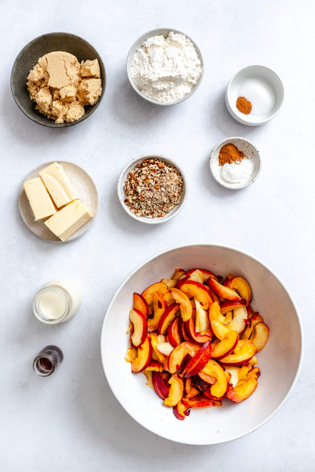 Ingredients for brown sugar peach cobbler in dishes.