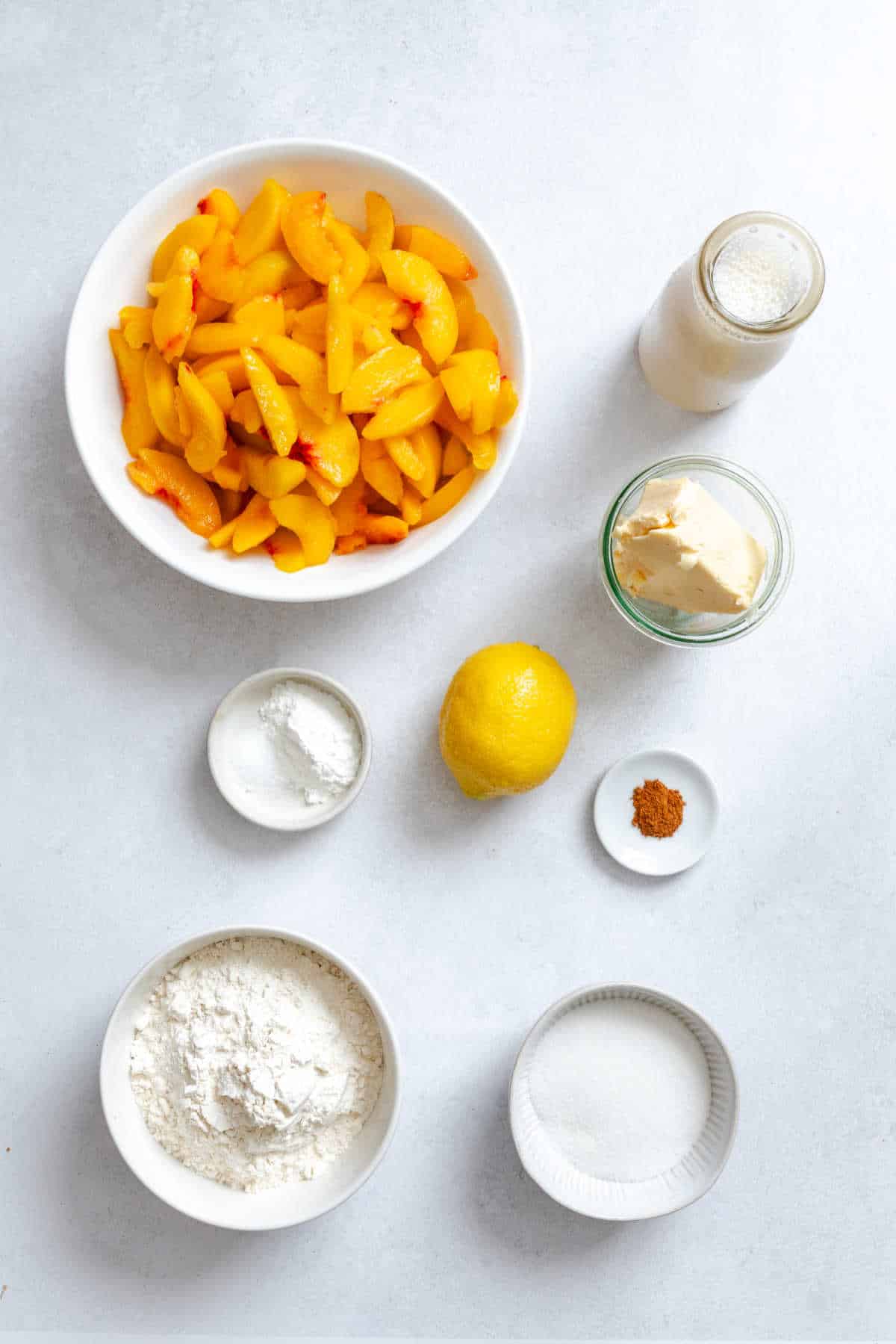 Ingredients for upside down peach cobbler in dishes.