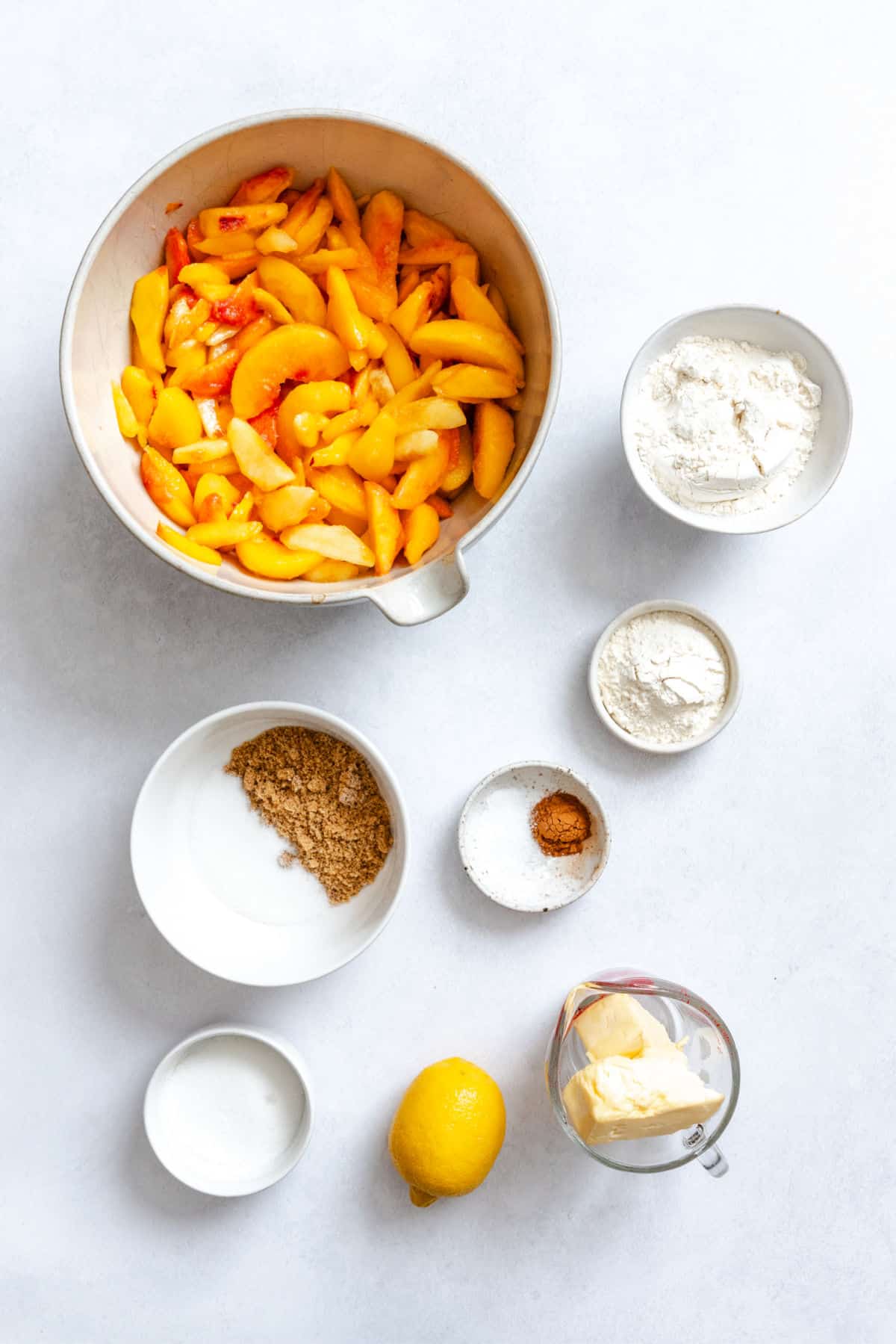 Ingredients for peach crumble in dishes. 