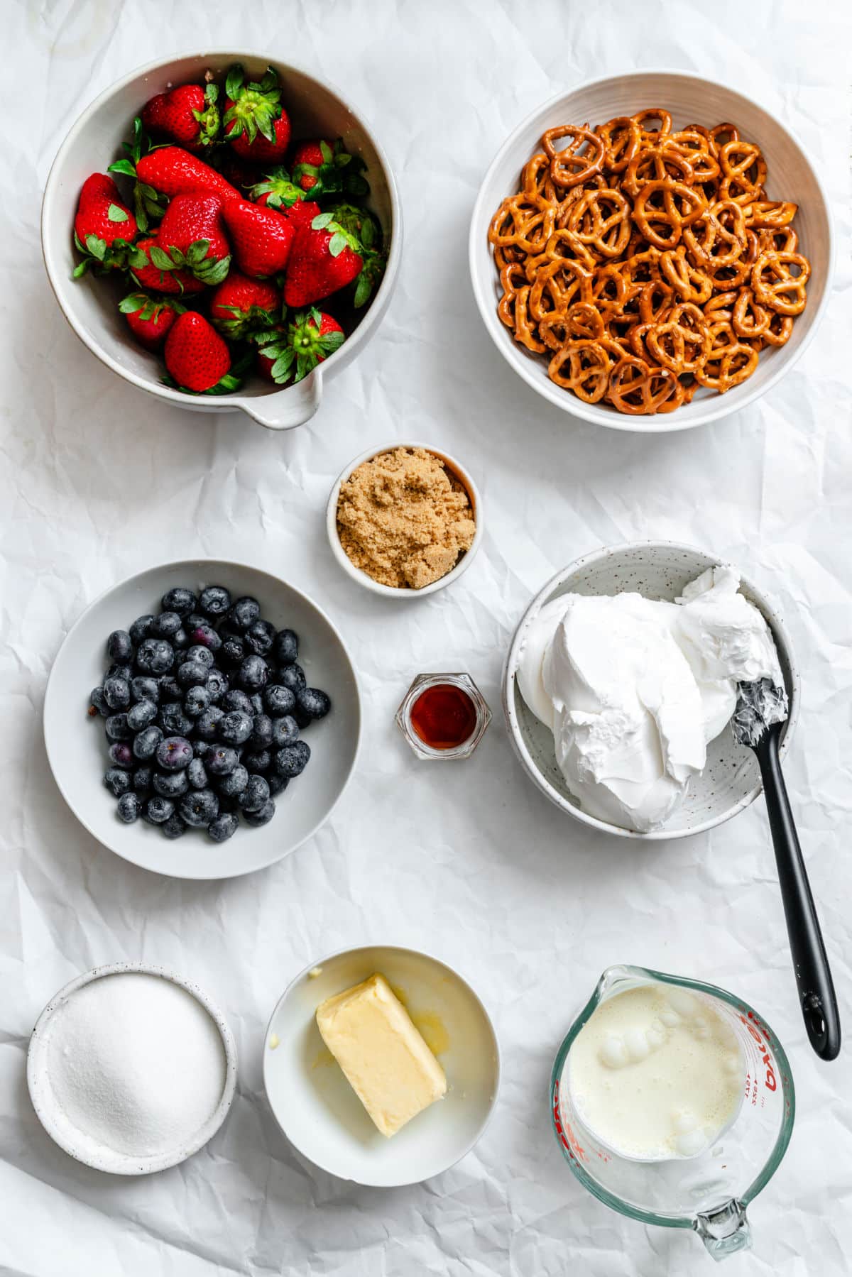 ingredients for red white and blue pretzel salad in dishes.