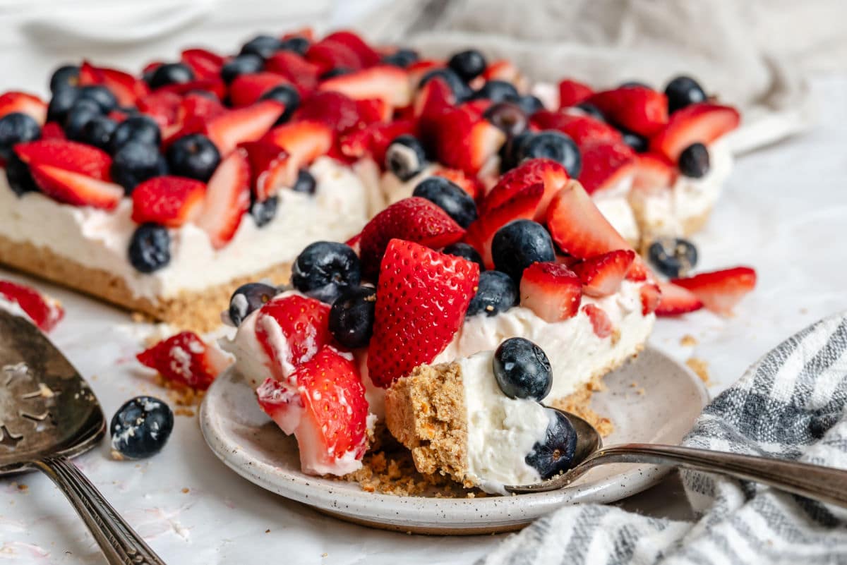 A piece of red white and blue pretzel salad on a plate.