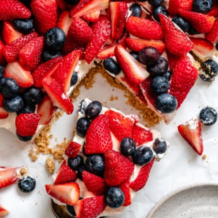 A slice of pretzel salad on a server next to the dish.
