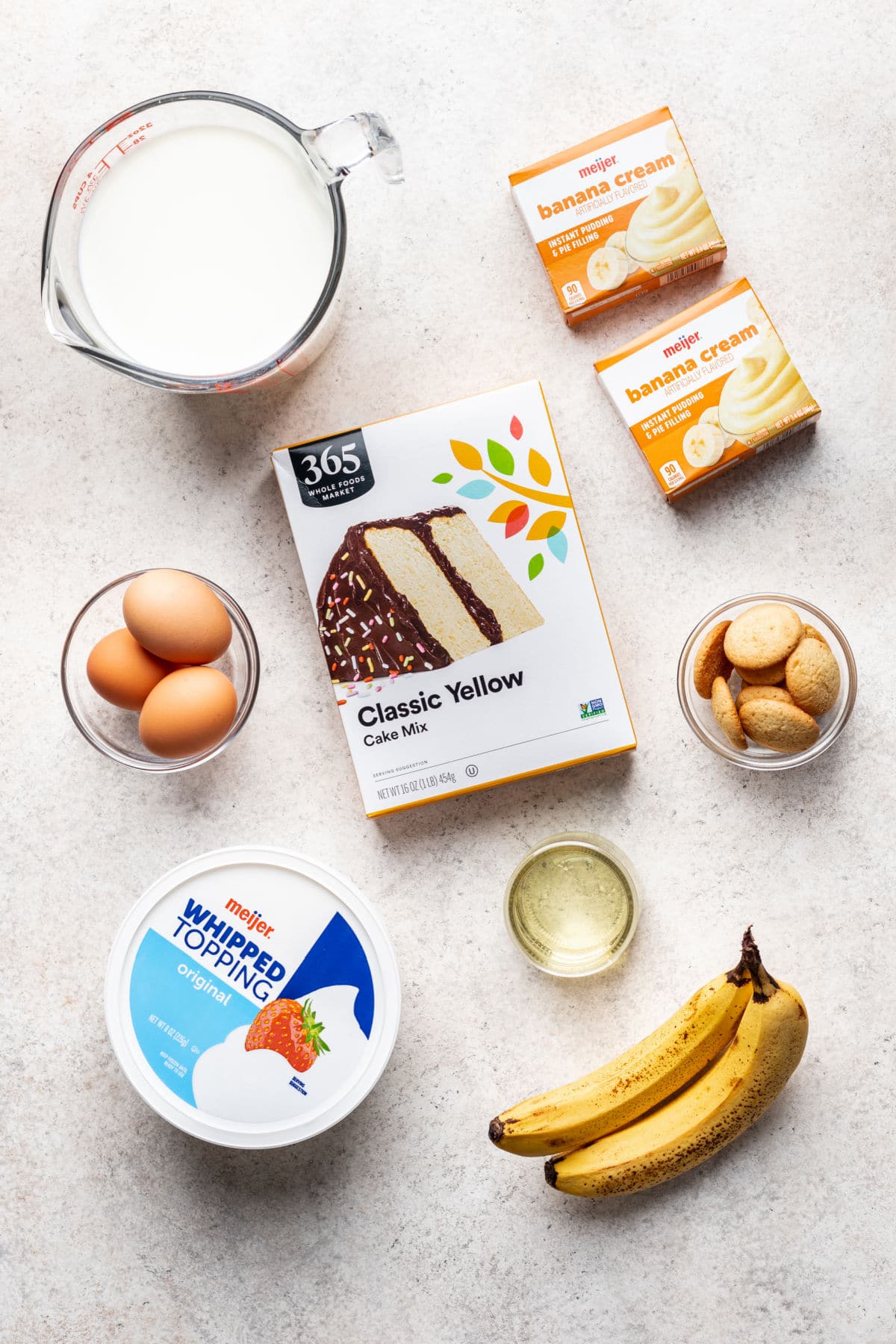 Ingredients for banana pudding poke cake in dishes.