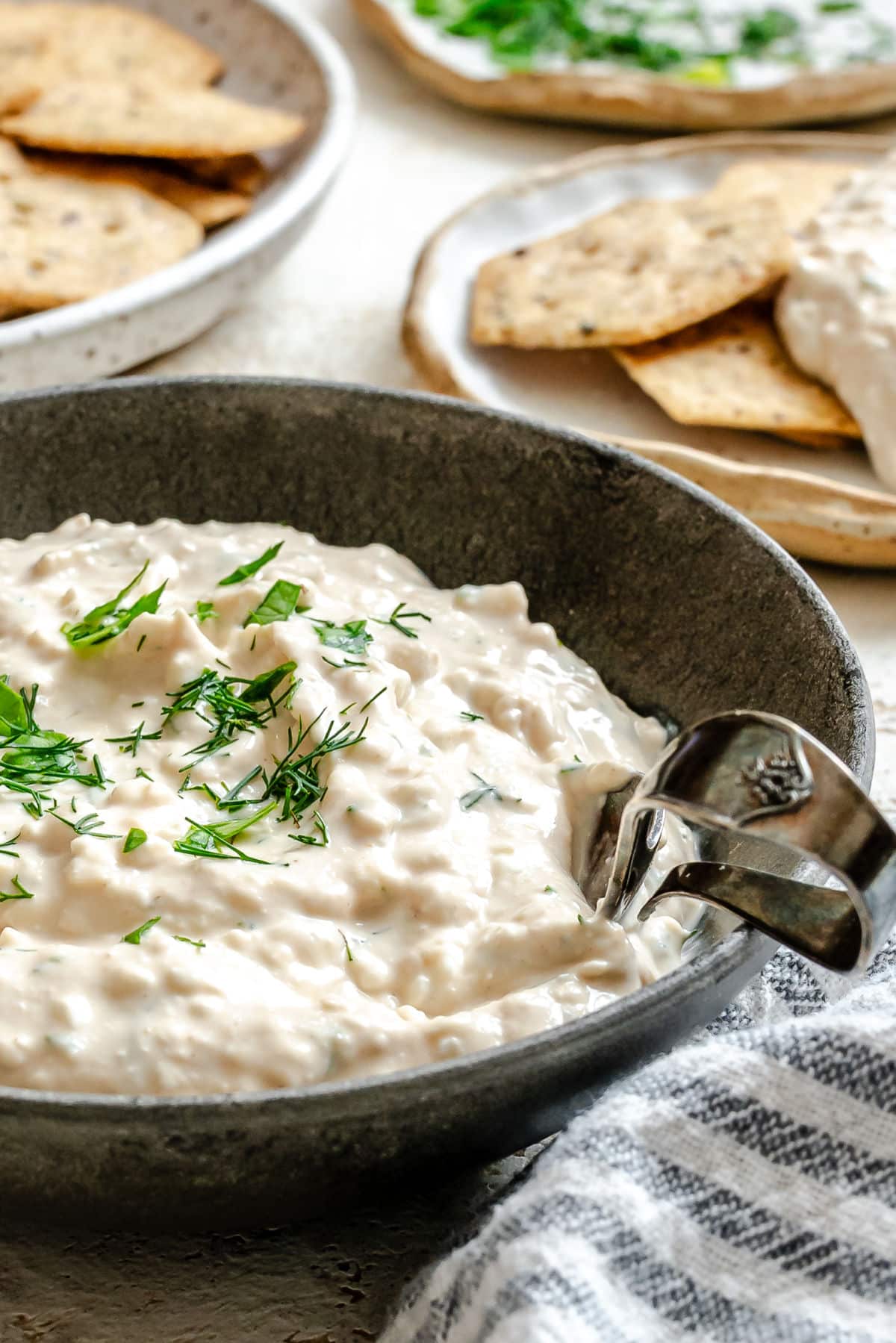 A dish of cottage cheese herb dip with a vintage spoon in it. 