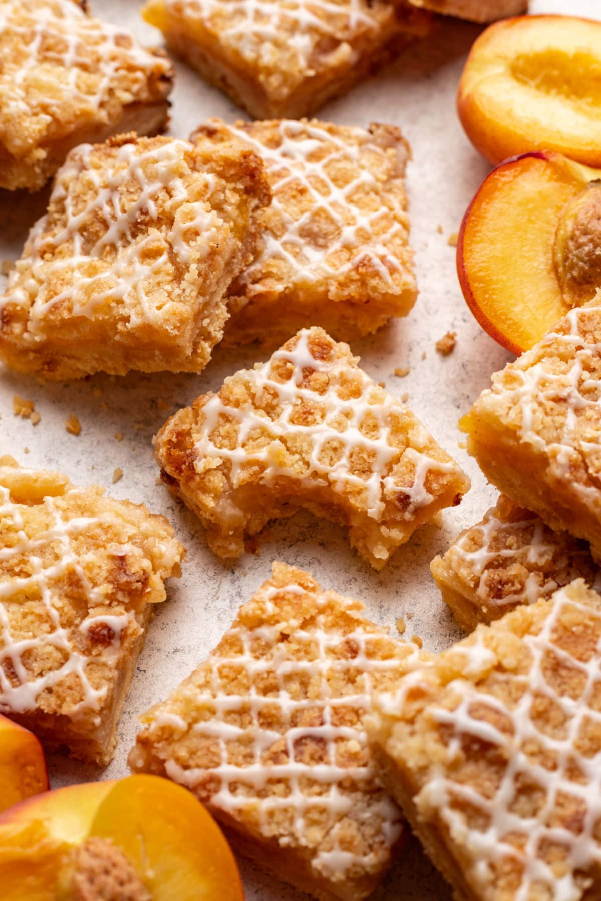 Peach crumb bars - I eat the heart Peach crumbs bar with a bite of it in the middle of more bars.