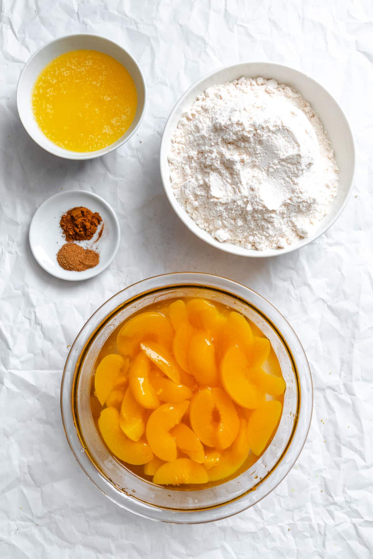 Ingredients for peach dump cake in dishes.
