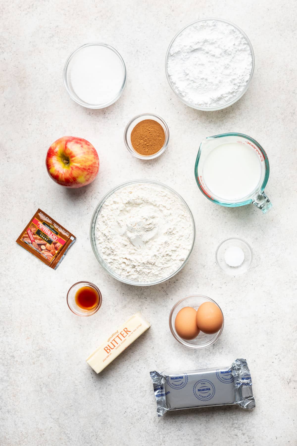 Ingredients for apple cinnamon rolls in dishes.
