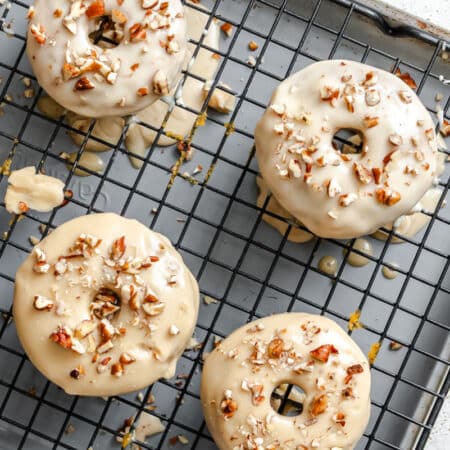 Baked sweet potato donuts on a wire cooling rack.