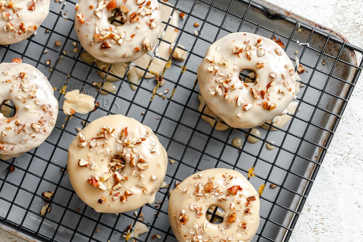 Baked sweet potato donuts on a wire cooling rack. 