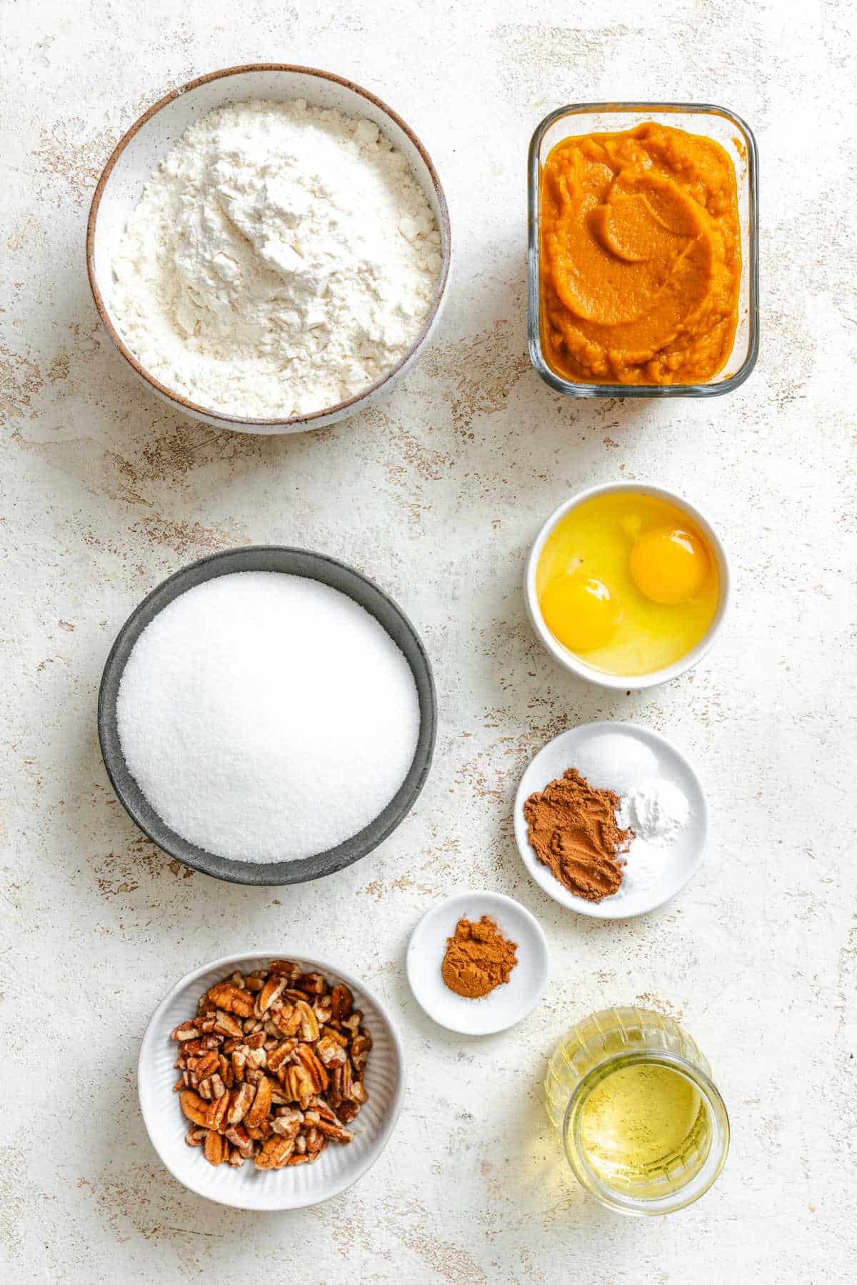 Ingredients for cinnamon sugar pumpkin bread in dishes.