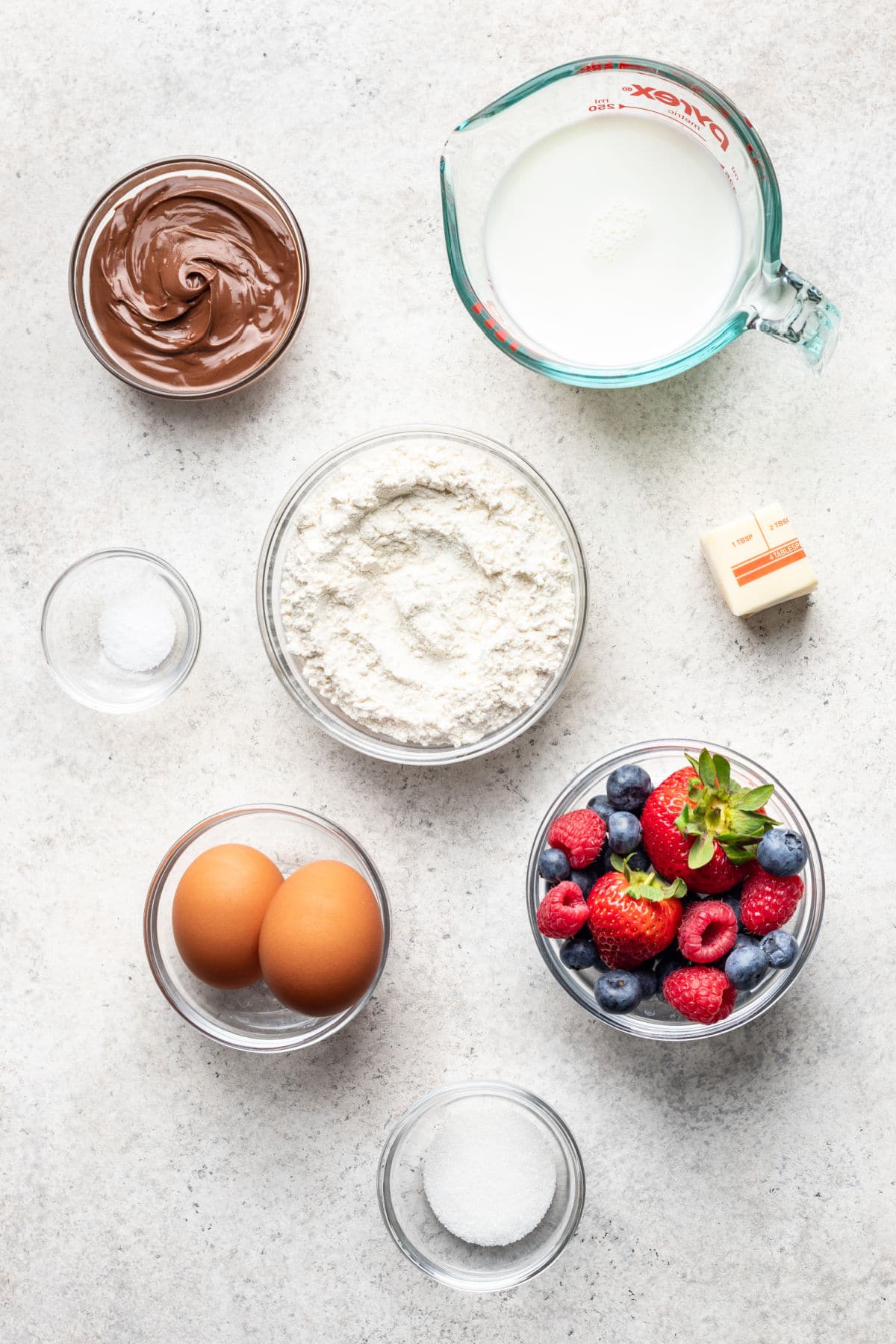Ingredients for crepes in dishes.