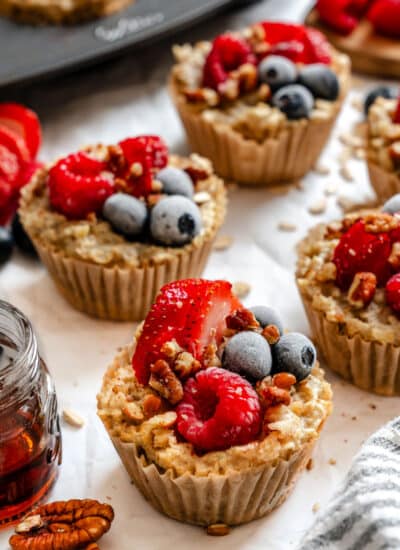 Rows of freezer oatmeal cups on white parchment paper.