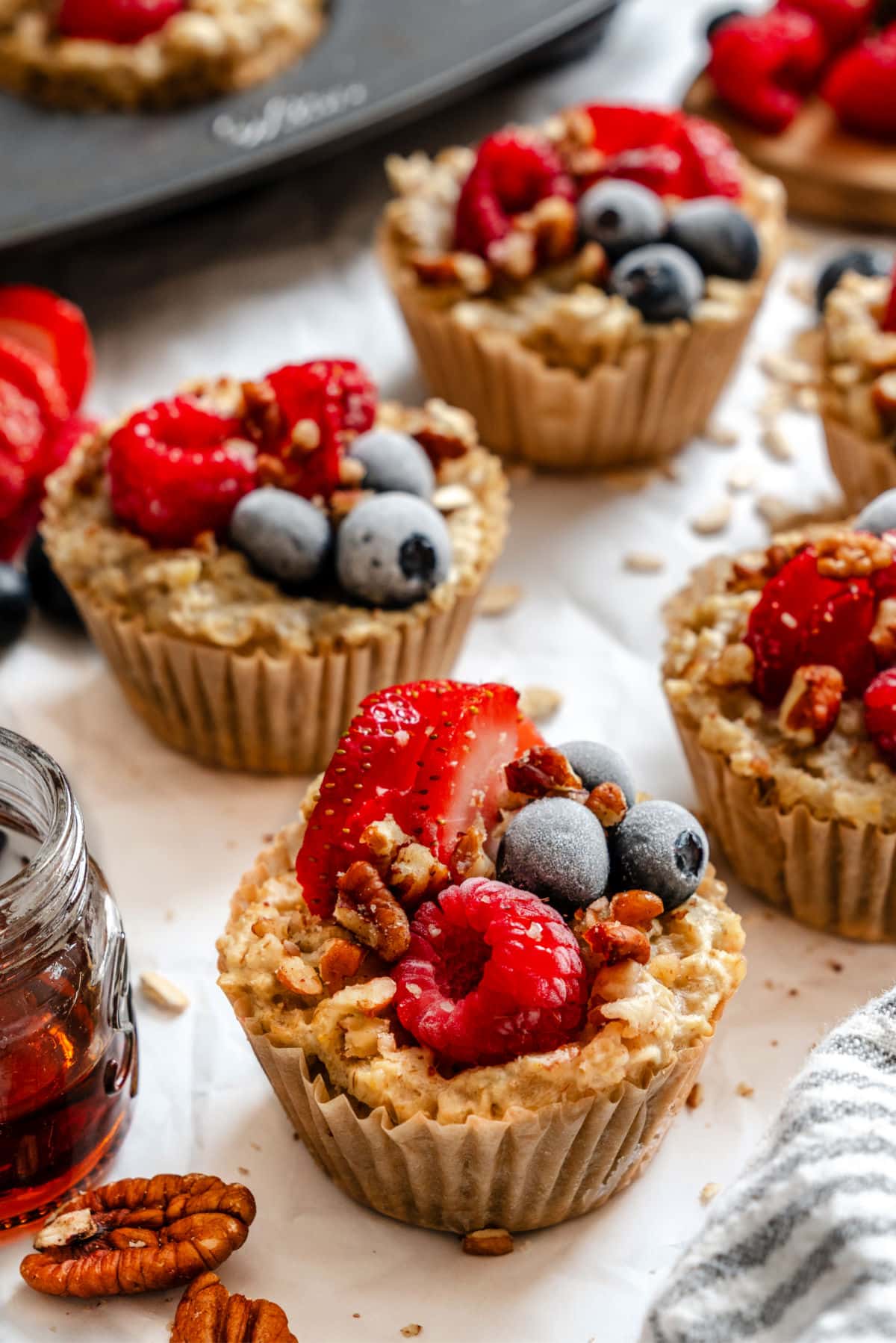 Rows of freezer oatmeal cups on white parchment paper. 