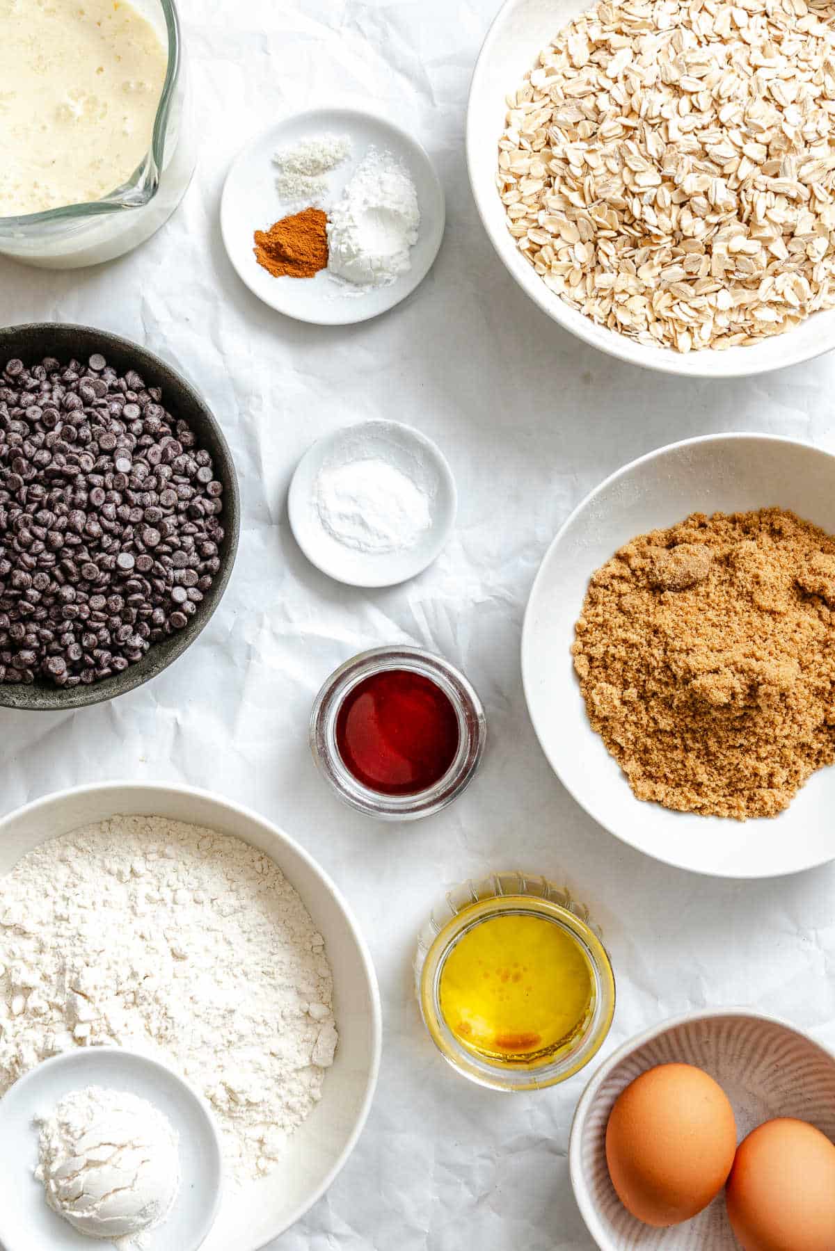 Ingredients for oatmeal chocolate chip muffins in dishes. 