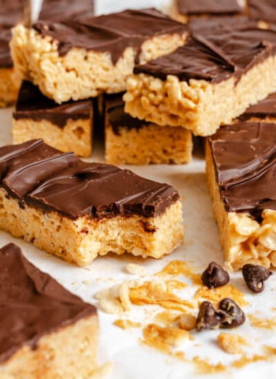 A stack of peanut butter Rice Krispies treats with a bite missing.
