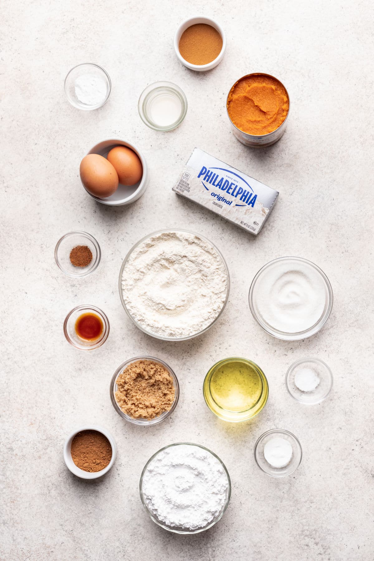 Ingredients for pumpkin cream cheese muffins in dishes.