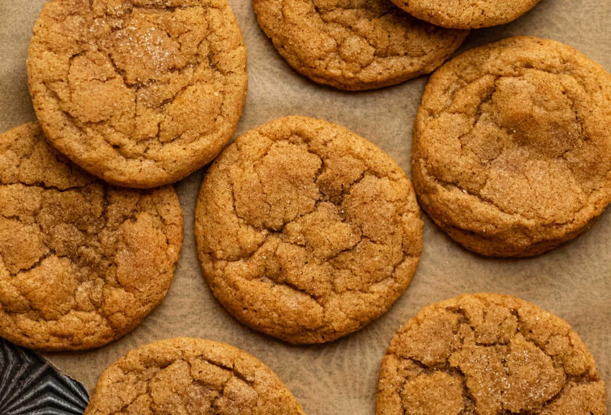 Overlapping rows of pumpkin snickerdoodles on a vintage baking sheet. 