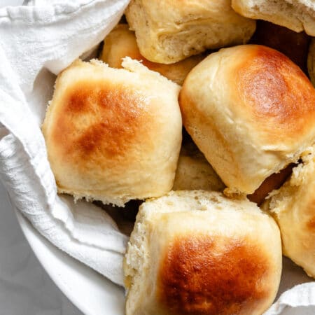 60 Minute Hawaiian rolls in a towel lined basket.