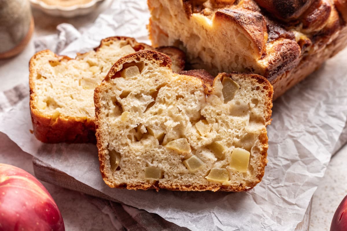 Two slices of apple cinnamon bread on parchment paper. 