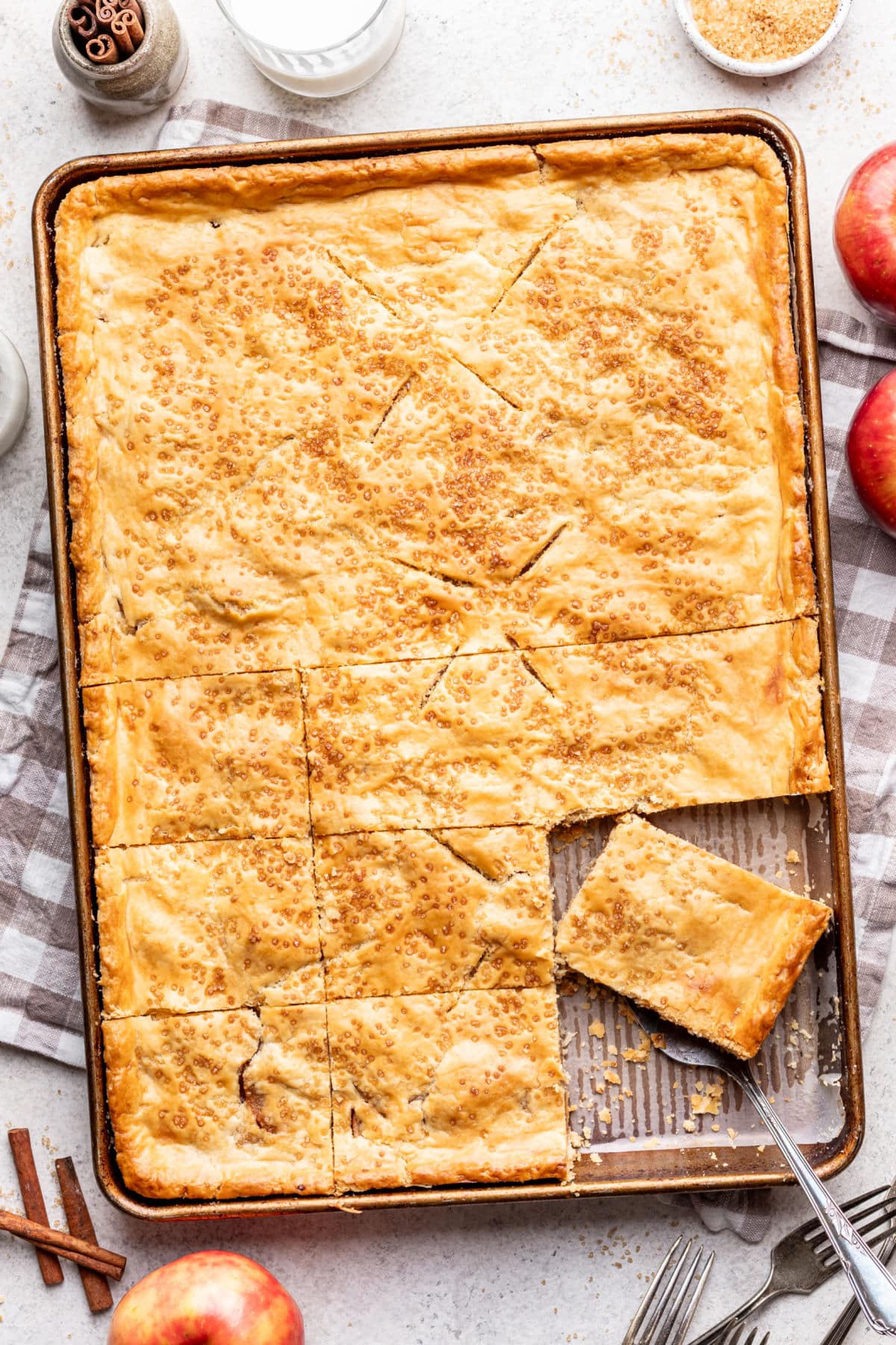Apple slab pie with a pie at an angle on a server. 