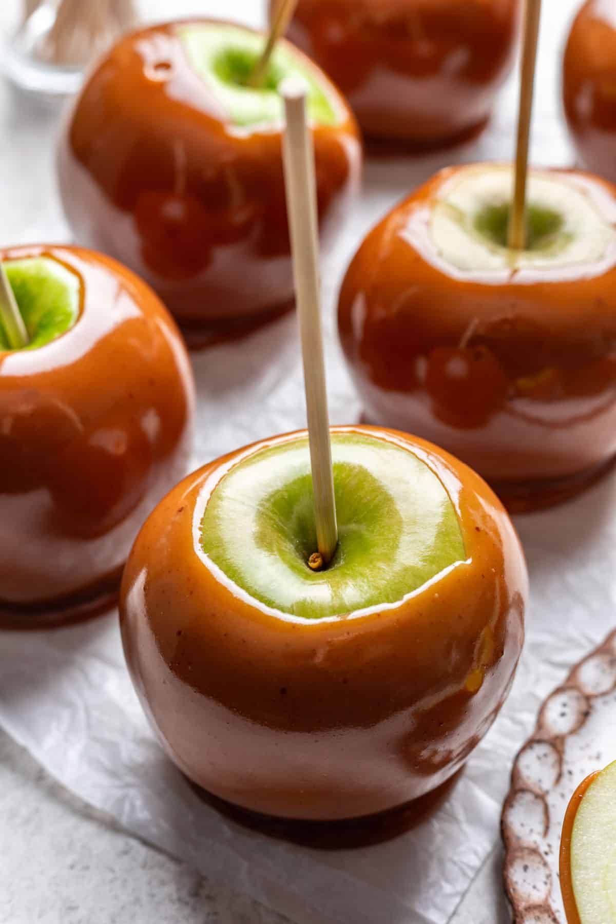 Pommes caramélisées maison sur une feuille de papier sulfurisé.
