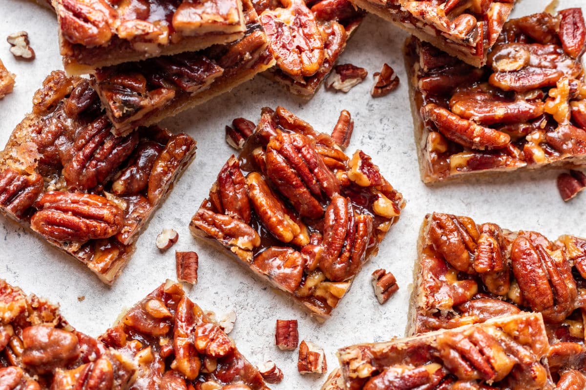 Pecan pie bars at an angle overlapping each other. 