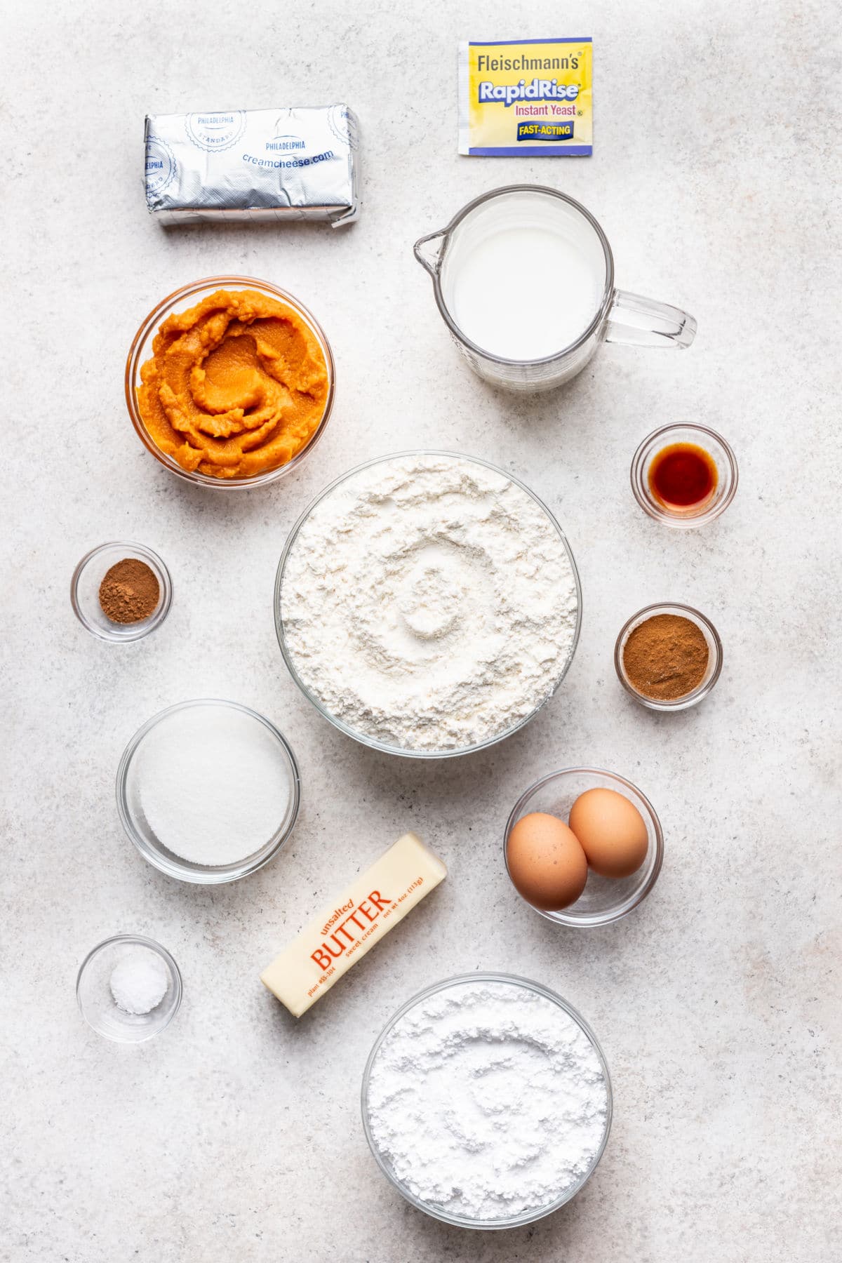 Ingredients for pumpkin cinnamon rolls in dishes.