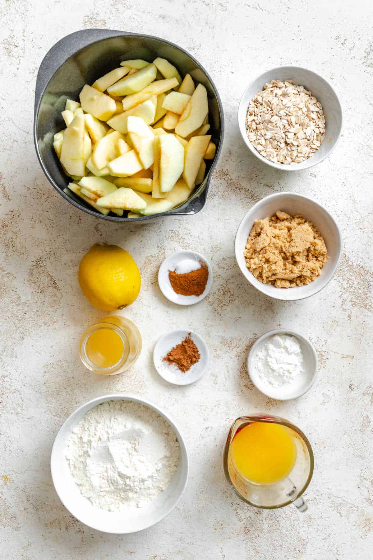 Ingredients for slow cooker apple crisp in dishes.
