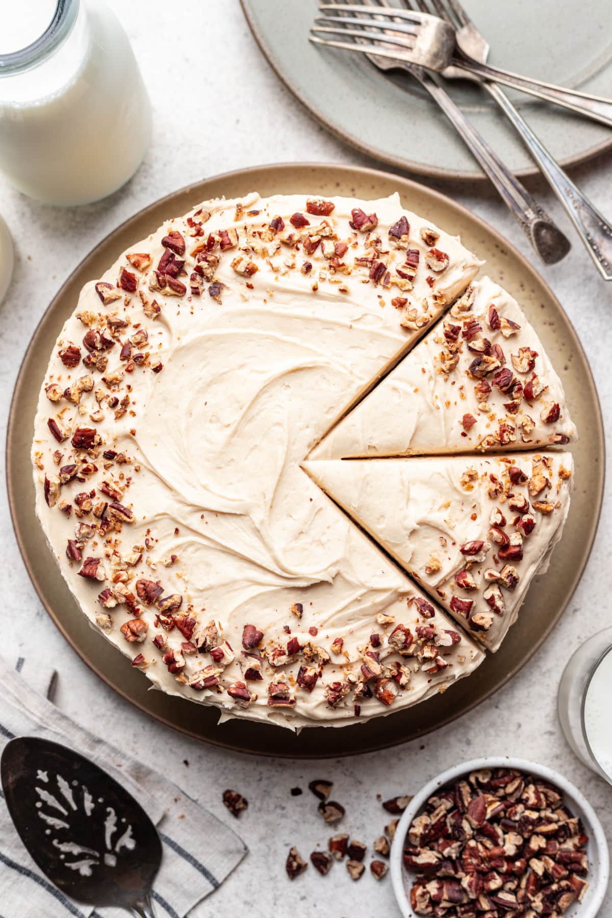 A sweet potato layer cake on a platter with two pieces cut. 