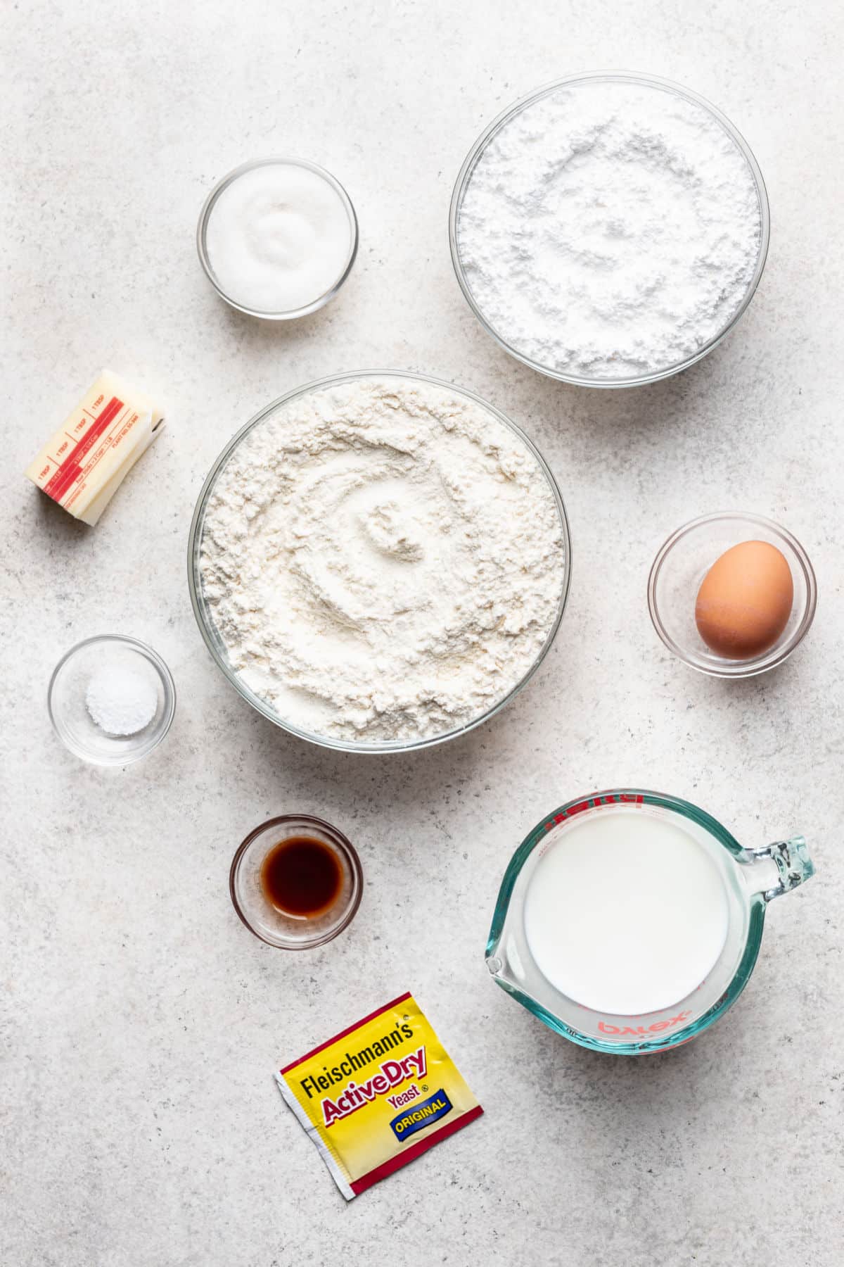 Ingredients for yeast glazed doughnuts in dishes.