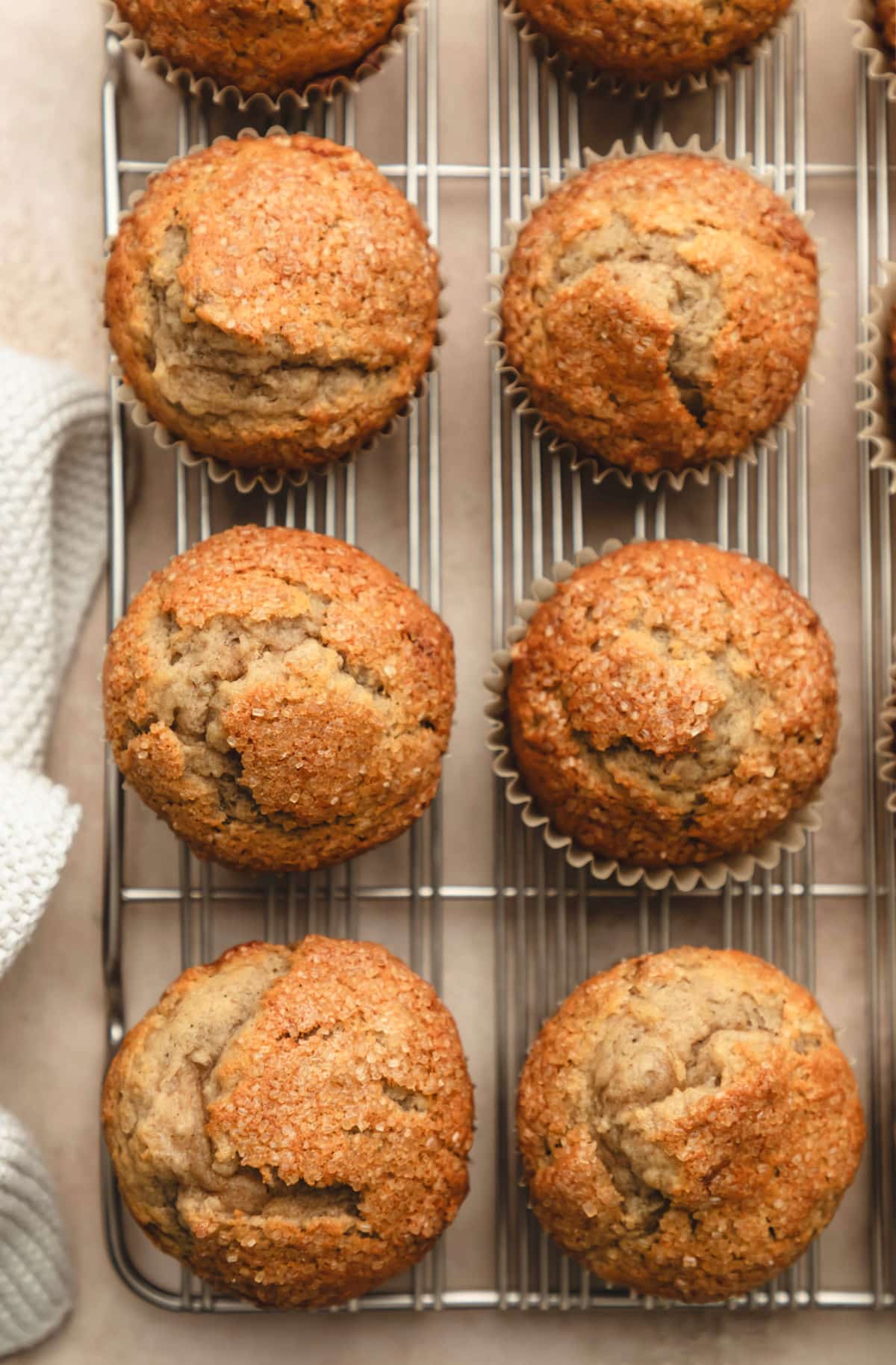 Rows of maple banana muffins on a wire cooling rack. 