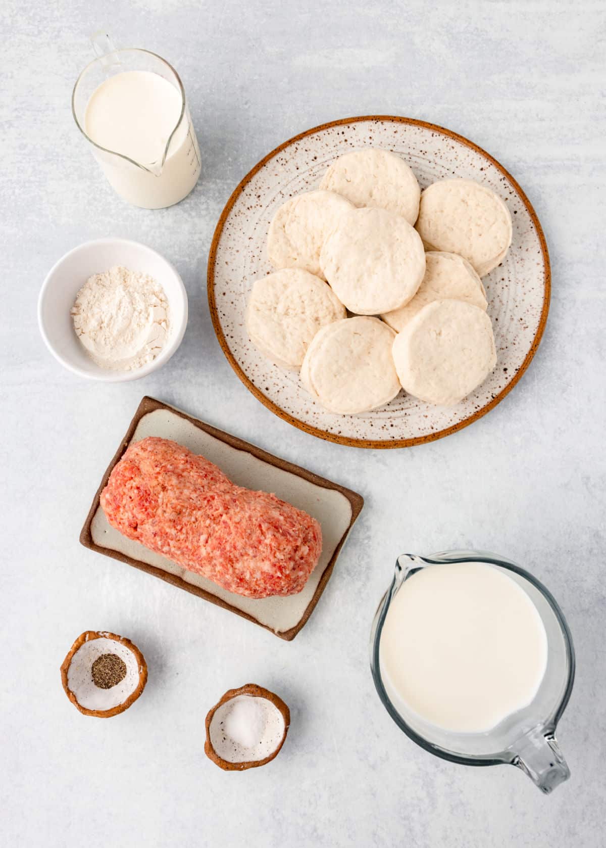 Ingredients for biscuits and gravy casserole in dishes. 