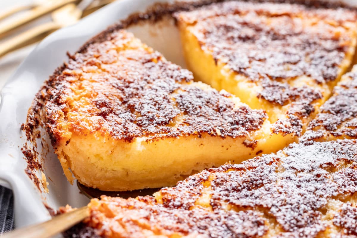 A cut piece of buttermilk pie in the pie pan.