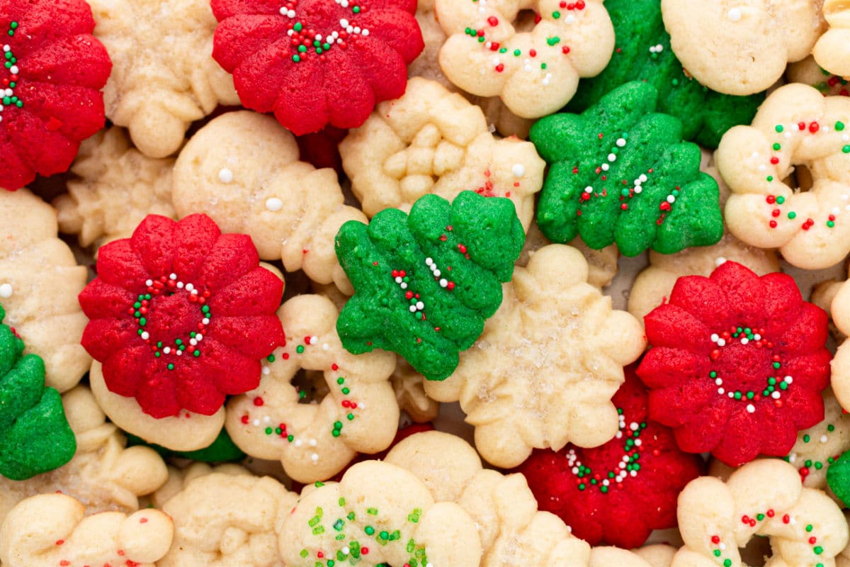 Christmas tree spritz cookie on top of other shaped spritz cookies. 