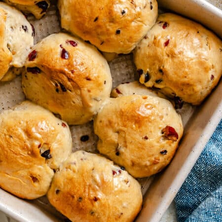 A pan of cranberry wild rice rolls at an angle.