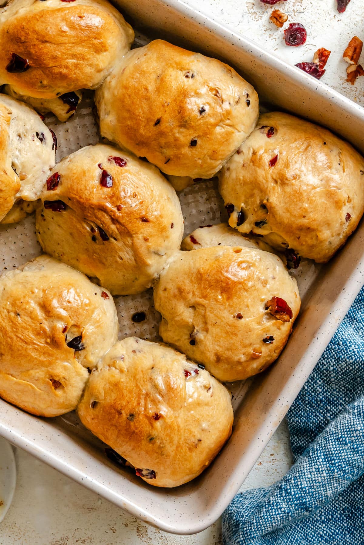A pan of cranberry wild rice rolls at an angle.