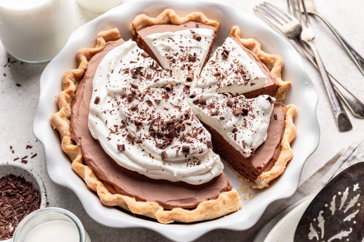 A French silk pie in a pie pan with forks and a server next to it. 
