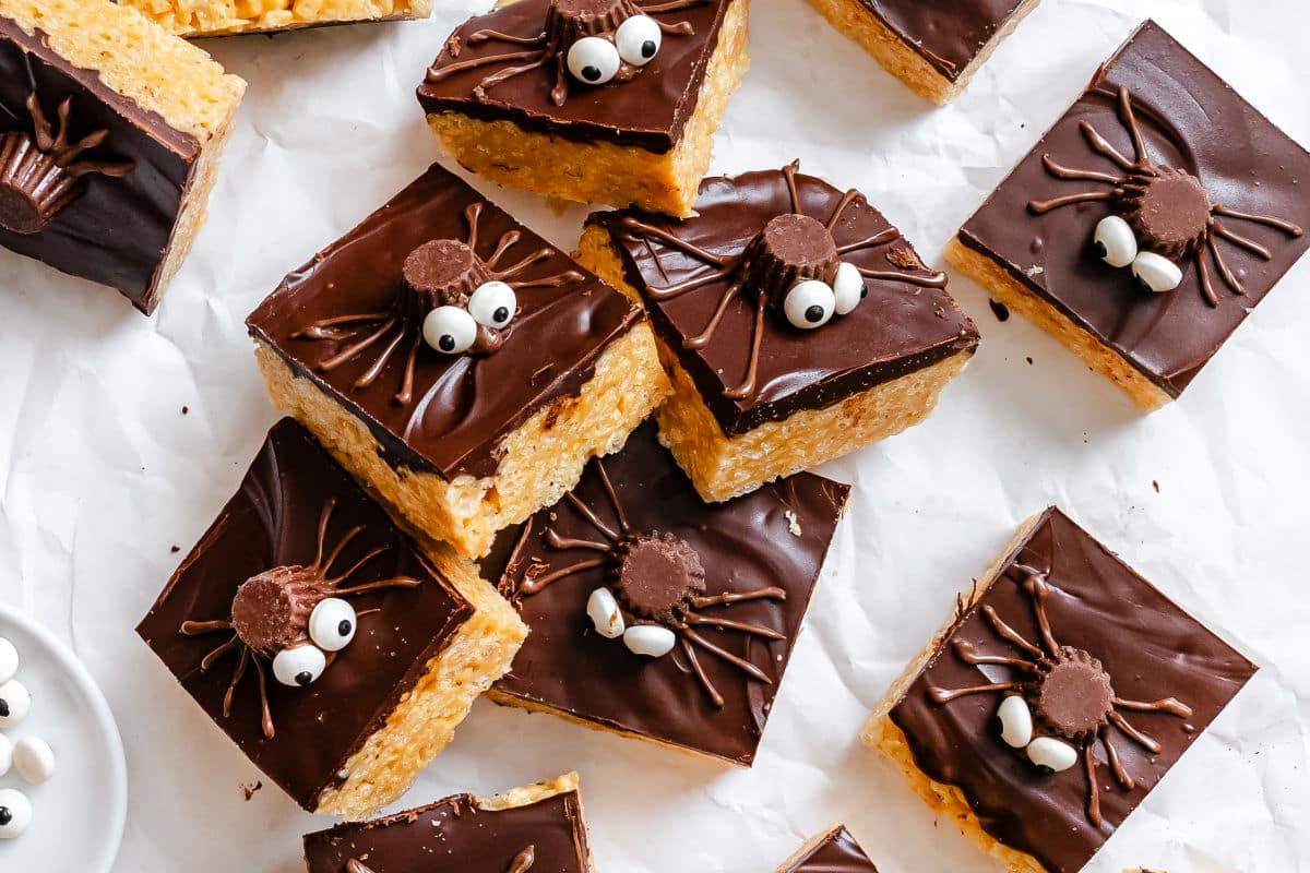 Halloween Rice Krispies treats next to a dish of candy eyes. 
