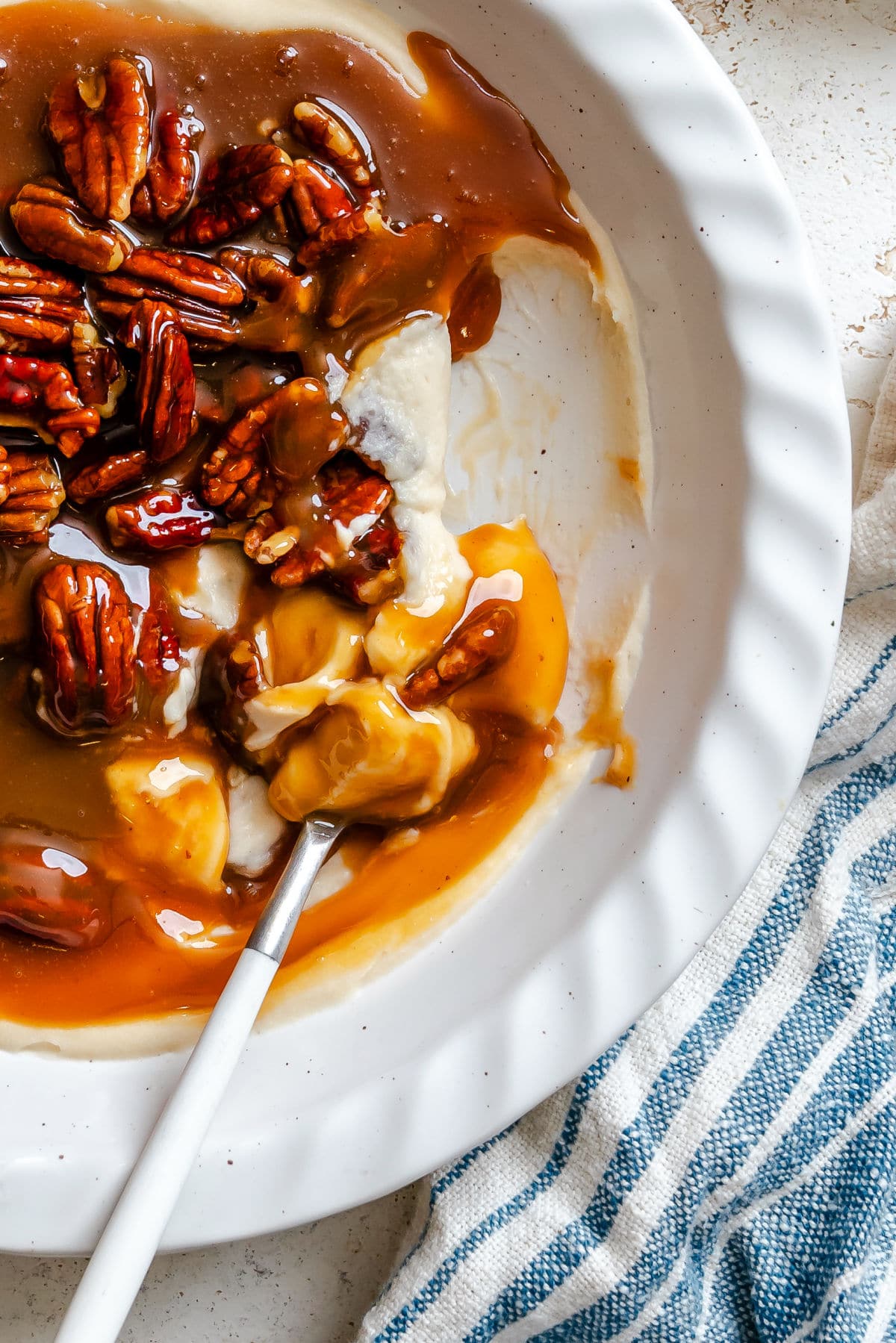 A spoon holding a scoop of pecan pie dip. 
