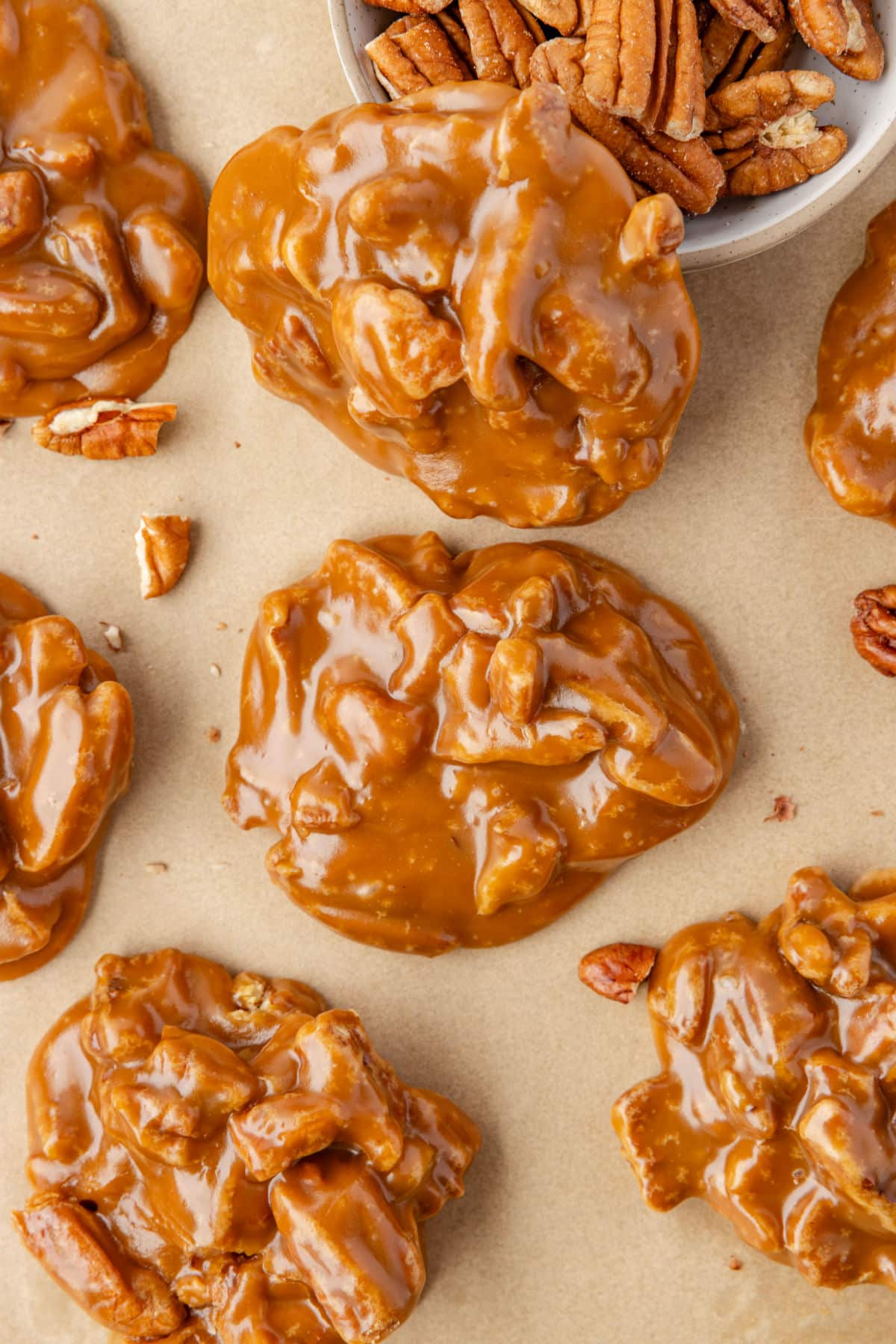 Pecan pralines on a piece of brown parchment paper. 
