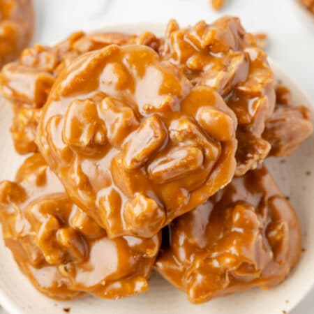 A plate of overlapping pecan pralines.