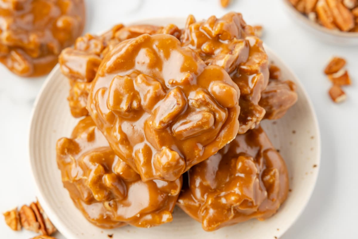 A plate of overlapping pecan pralines. 