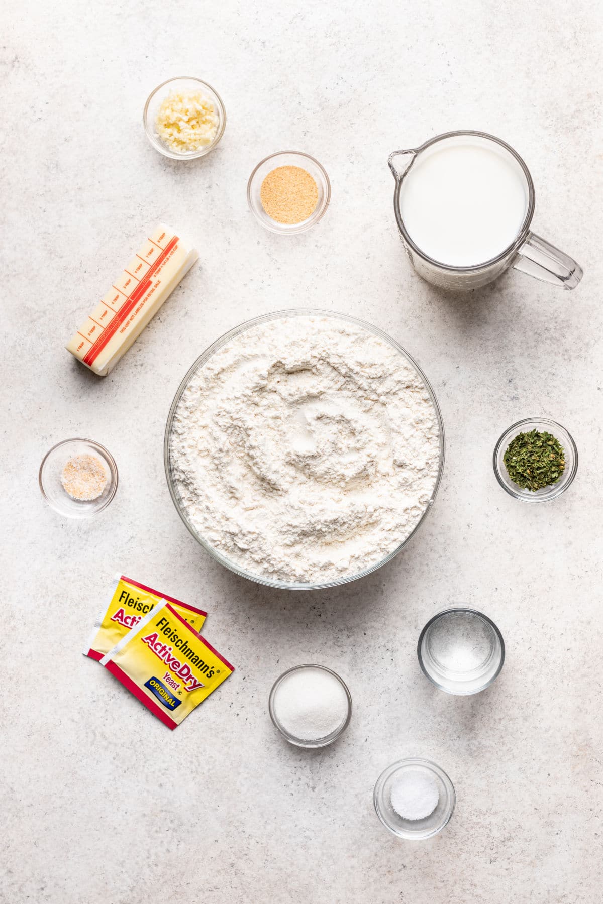 Ingredients for garlic pull apart bread in dishes.