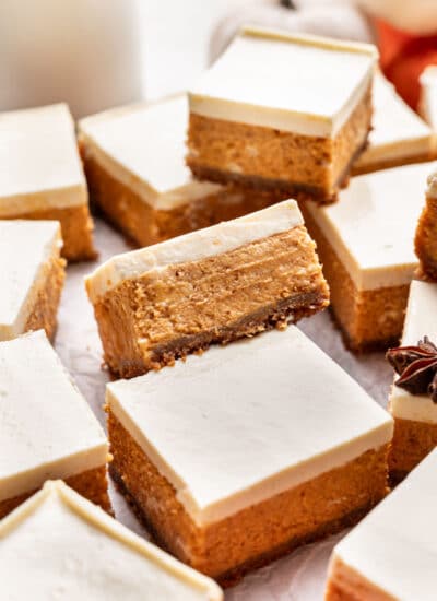 Cut pumpkin cheesecake bars at an angle on top of each other.