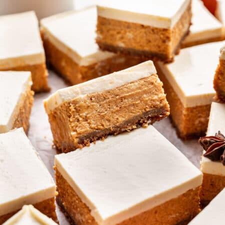 Cut pumpkin cheesecake bars at an angle on top of each other.