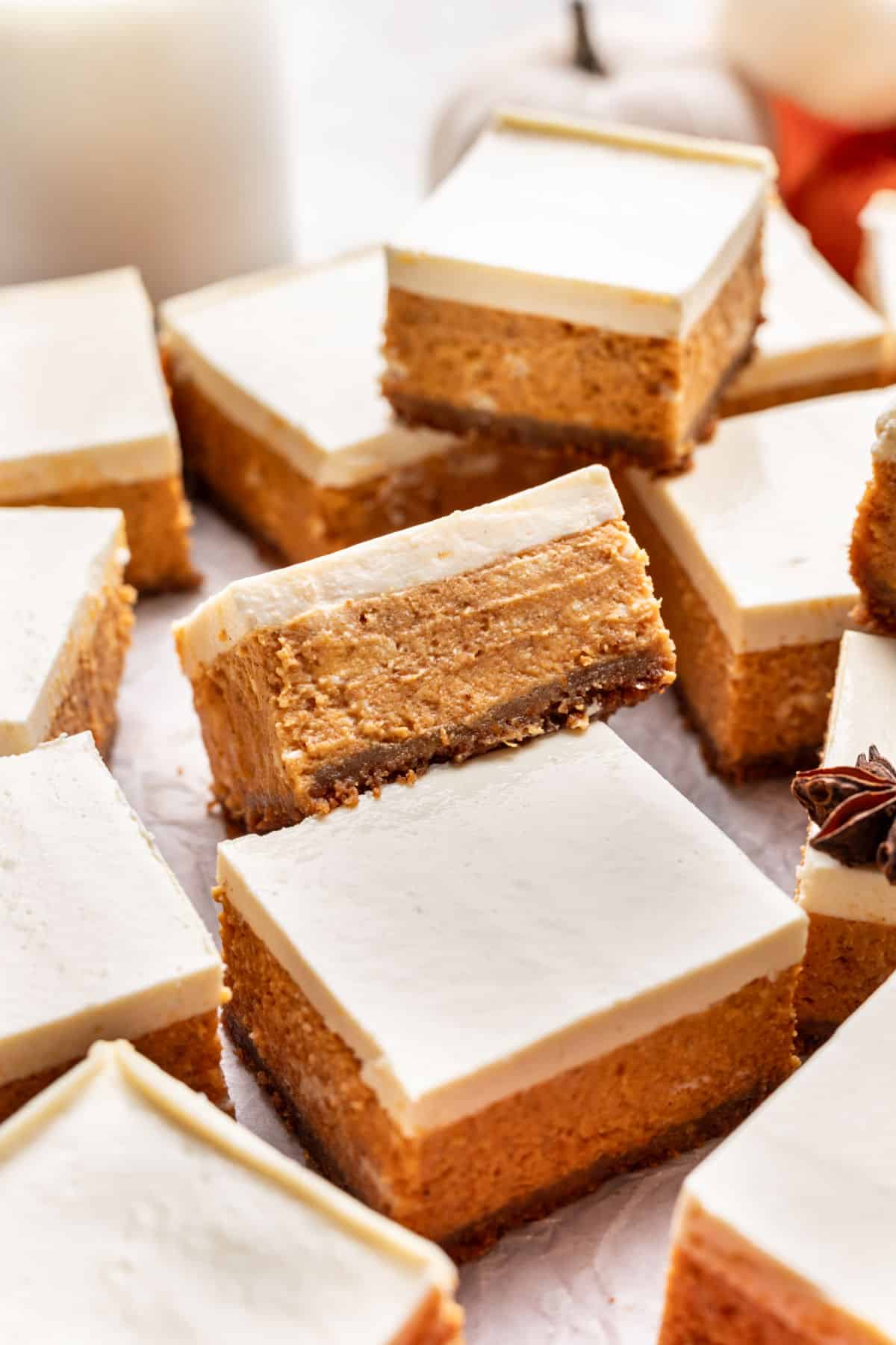 Cut pumpkin cheesecake bars at an angle on top of each other.